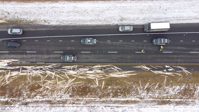 Lumber spill on Highway 30 in snowy Candiac, Canada, after a jackknife accident