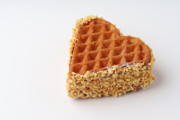 Heart-shaped waffle coated in crunchy nuts showcases delightful dessert appeal