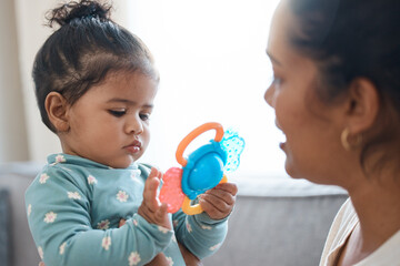 Home, mother and baby with toys for playing, childhood development and bonding together in lounge. Family house, woman and girl with curiosity for plastic object, learning and parenthood for mom
