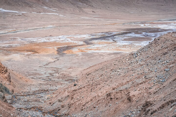 Mountain river flows in high-mountain Tien Shan among stones in the valley of rocks, riverbed bends...