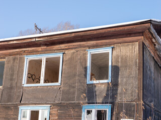 A house with a black siding and blue windows