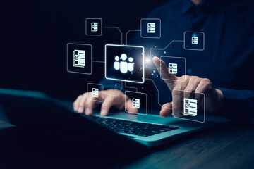 Digital human resource management concept. A businessman interacts with a virtual HR system, managing employee data, recruitment, and task automation through a futuristic interface on a laptop.