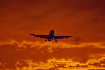 Obraz premium Photo - Airplane Silhouette Against Fiery Sunset Sky
