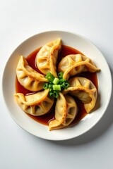Savory Steamed Dumplings Arranged in a Circular Pattern on a Plate with a Rich Sauce and Garnish