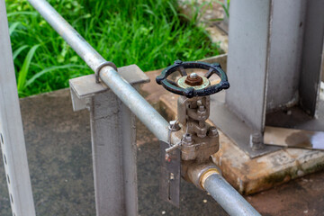 Close-up of an industrial valve on a metal pipe