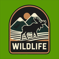 A green background with a sun and mountains. A moose is walking in the foreground. The word "wildlife" is written below the moose