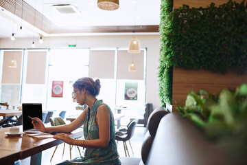 Cafe, businesswoman and laptop with notebook for remote work, news story and content writer for blog. Restaurant, female person and journalist with journal for article notes, draft angle or freelance