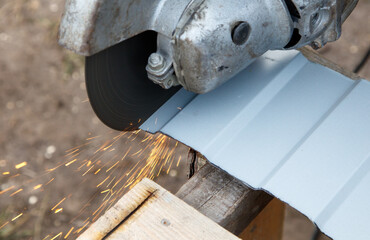 A metal cutting tool is cutting through a piece of metal