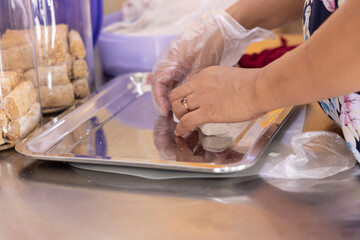 Hand of woman preparing dough and sweet snack in the kitchen.