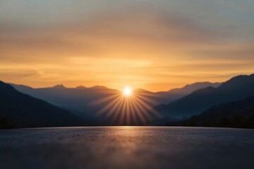 Sunrise over a mountain range, captured from a high vantage point with the sun’s rays spreading across the sky. Peaceful and scenic landscape concept.