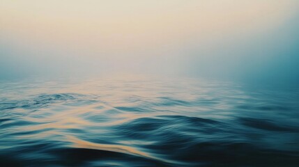 Obraz premium Hazy horizon merges with calm sea, capturing tranquility through the soft dance of ripples beneath a pastel sky.
