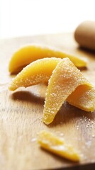 Sliced sugary candied mango on wooden board for culinary presentation. National Candied Orange Peel Day
