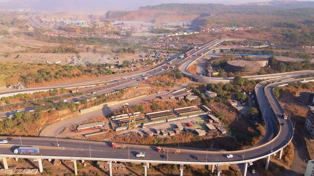 Aerial view freeway with looping bridges and speeding vehicles