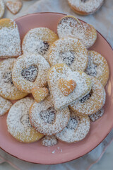 Linzer cookies with heart with raspberry jam and powdered sugar 