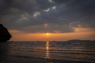 Beautiful landscape of the Andaman Sea and cloudy sky during sunset at the Railay West Beach in Railay, Krabi, Thailand.