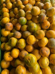 Vibrant orange green citrus fruits piled together,showcasing freshness and natural appeal.perfectly showcases a typical fruit market scene rich in natural textures and colors.