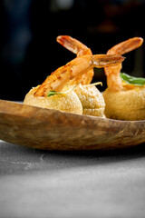 A vibrant and appetizing platter of crispy, golden-brown pastries filled with a savory filling and topped with fresh herbs.