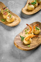 A vibrant and appetizing platter of crispy, golden-brown pastries filled with a savory filling and topped with fresh herbs.