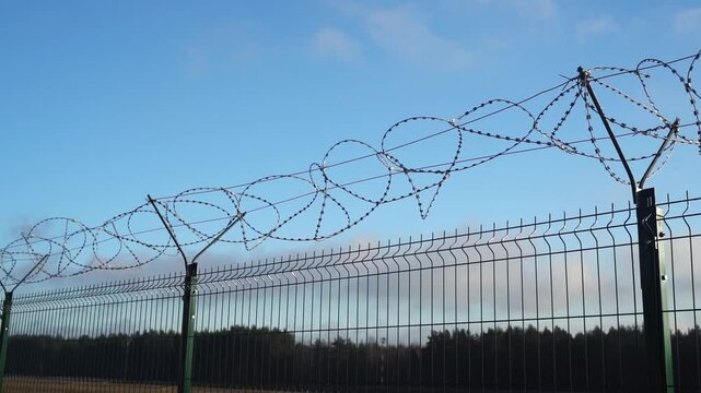 Barbed wire fence on the border. Protection and prohibition
