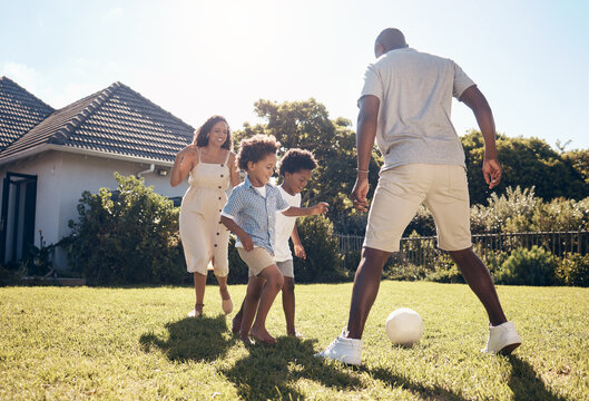 Happy, football and parents playing with children in backyard for bonding, adventure or family time. Fun, outdoor and kids learning soccer with mom and dad in garden for sports development on grass. - Powered by Adobe