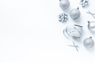 Silver colored Christmas and New Year decorations on white background, top view
