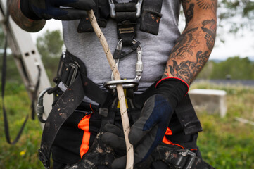 Close up of a technician's harness tying off the rope