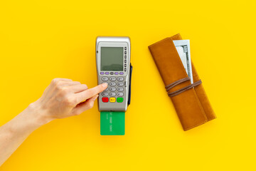 Female holding in hands bank payment terminal for contactless payment by credit cards, top view