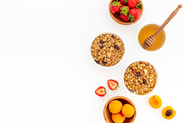 Flat lay of oatmeal granola and ingredients served on white table. Healthy breakfast
