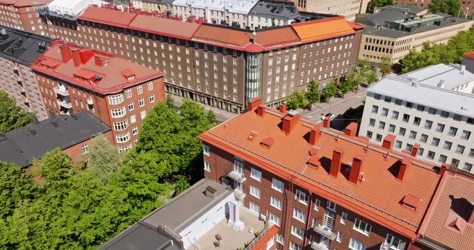 Aerial view rotating over traditional buildings in Toolo, sunny, summer day in Helsinki