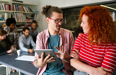Group of business people and software developers working as a team in modern startup office