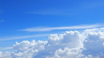 A stunning aerial view showcasing a vibrant blue sky filled with fluffy cumulus clouds on a sunny day.