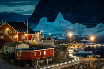 View of beautiful colorful greenlandic houses in a small picturesque village Uummannaq during evening with giant floating icebergs in backrgound. West Greenland. Autonomous territory of Denmark.  © Ji