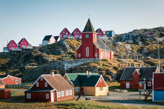 View of colorful picturesque houses in Sisimiut dominated by wooden church during a sunny day. Start of Arctic Circle Trail, southwest Greenland. Autonomous territory of  Denmark. 