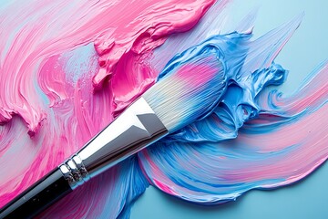 Fototapeta premium Brush dipped in vibrant pink and blue paint creating a stunning abstract pattern on a smooth surface
