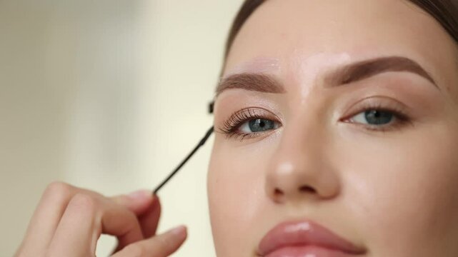 Brow grooming process: eyebrow correction with wax, removal of excess hairs.