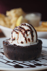 Delicious dessert with chocolate crust and ice cream sundae on plate