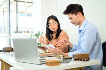 Interior designers analyzing color schemes and wood samples for a renovation project