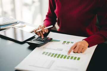 Accountant working on desk using calculator to calculate financial report in office business accounting finance concept