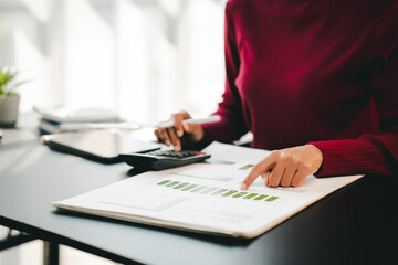 Accountant working on desk using calculator to calculate financial report in office business accounting finance concept