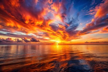 Fiery sunset over calm ocean; serene background