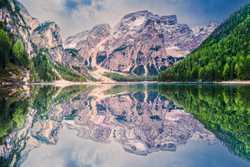 Lago di Braies, Italy. Alpine lake with emerald waters, dramatic Dolomites peaks, wooden boats, and...