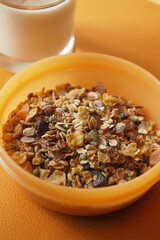 Healthy granola breakfast served in a bowl with milk