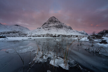 Buachaille Etive Beag mountain in Glencoe, Scotland at sunrise.
A frozen Loch with mountain landscape scenery in this highly detailed image.