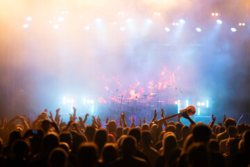 Crowd at concert and blurred stage lights.