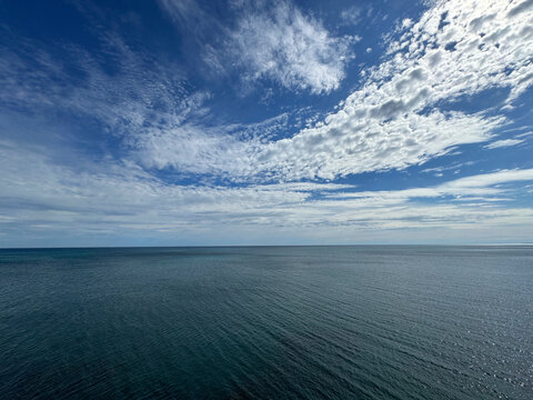 Sea blue shining waters and beautiful sky clouds horizon. 