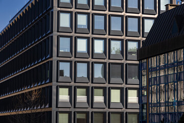 Modern building facade with large glass windows. Business office background