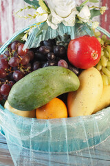 Colorful fruit basket filled with fresh produce and decorative accents