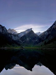 Fototapeta premium Magic photo of a lake reflecting the mountains during a hike in the Swiss Alps