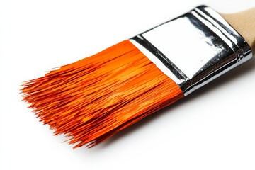 Fototapeta premium Bright orange paintbrush resting on a clean surface ready for artistic creation or home decoration projects