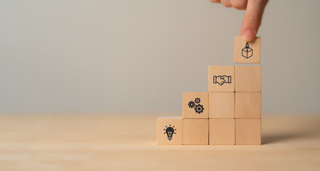 New product development and project roadmap concept. Wooden blocks with the stages of new product...